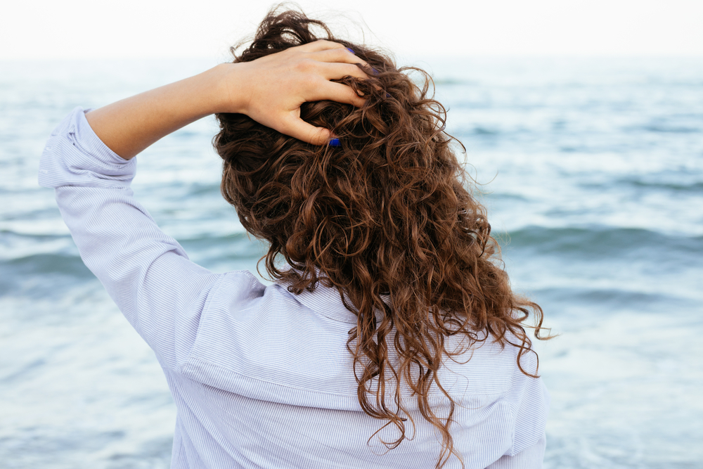 Young,Woman,In,Shirt,Looking,At,The,Sea,And,Keeps