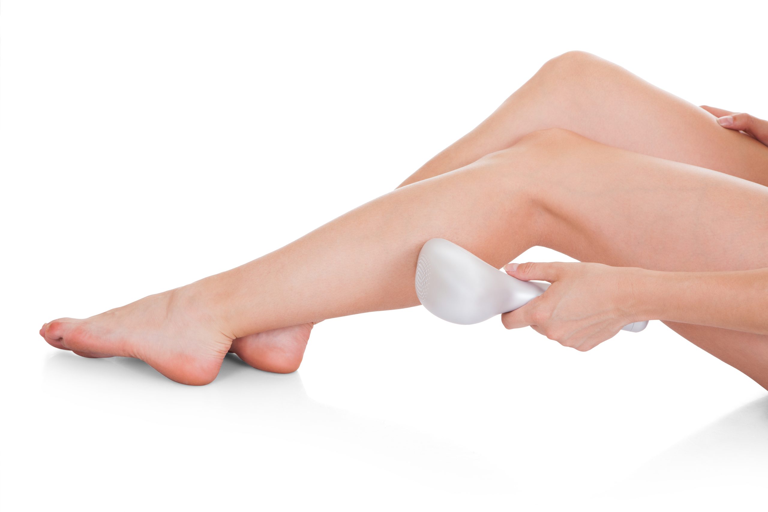 Close-up Of Woman Doing Leg Laser Treatment Over White Background